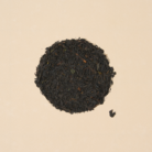 Saitama black tea leaves arranged inside a filled circle